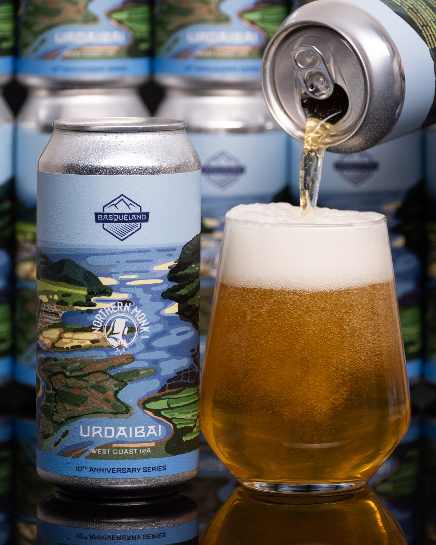Beer can being poured into a glass with 'Urdaibai' branding and scenic design.