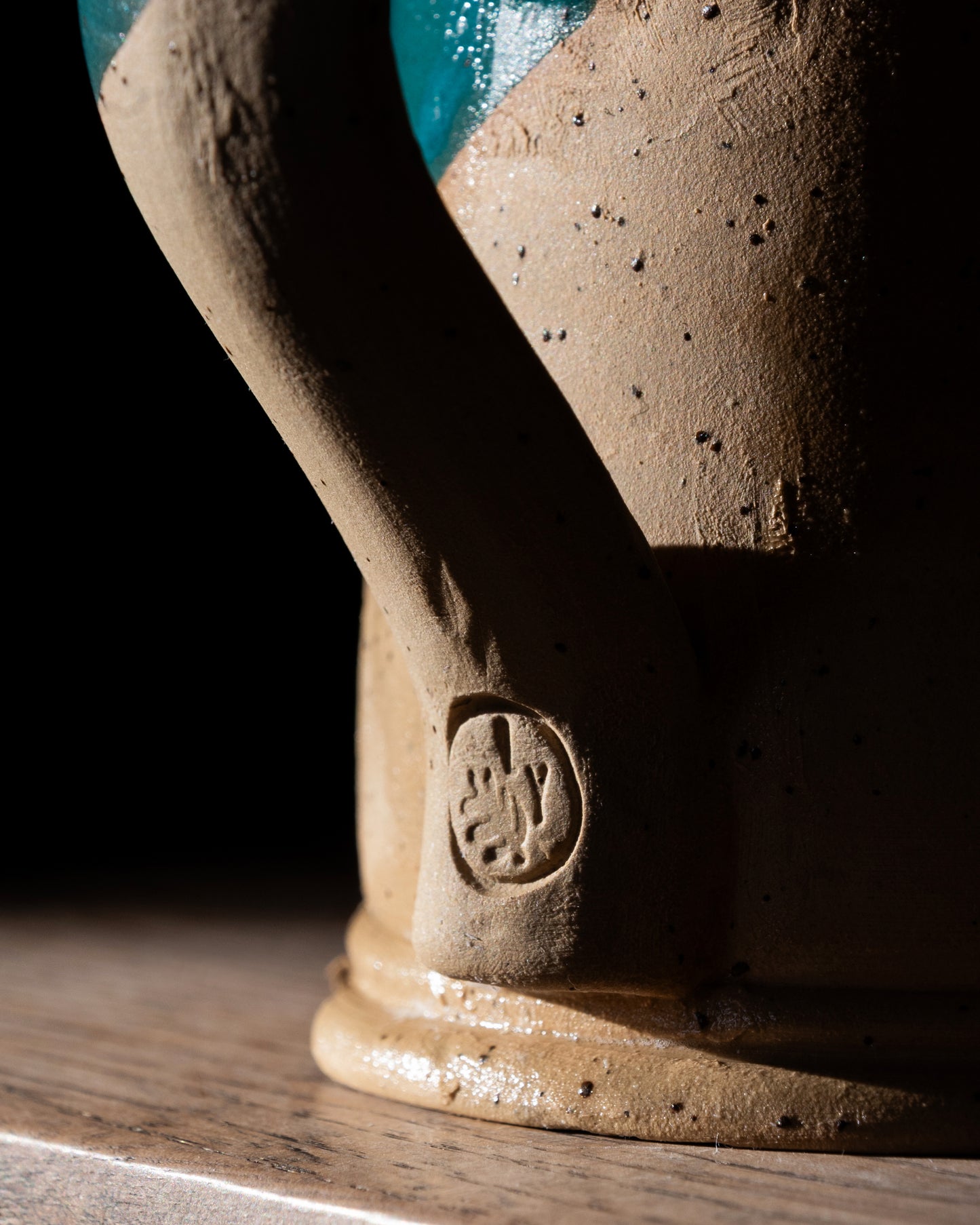 Close-up of a ceramic tankard with a visible Lucy Young brand 