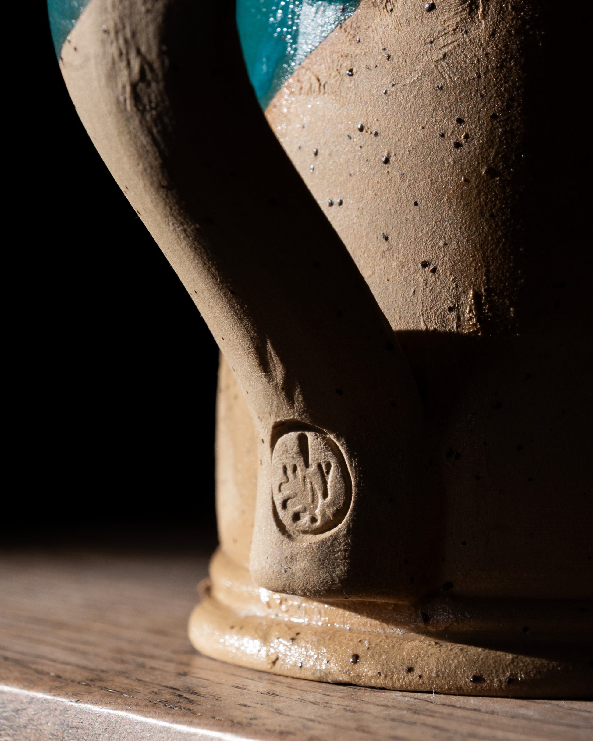 Close-up of a ceramic tankard with a visible Lucy Young brand 