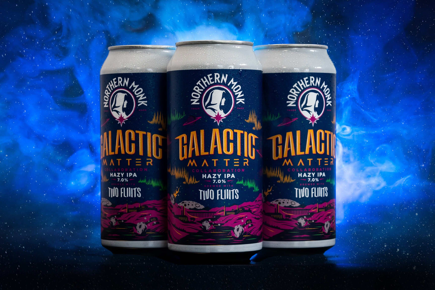 Three cans of Galactic Matter Hazy IPA by Northern Monk, cosmic design with vibrant colors, showcasing 7.0% ABV.